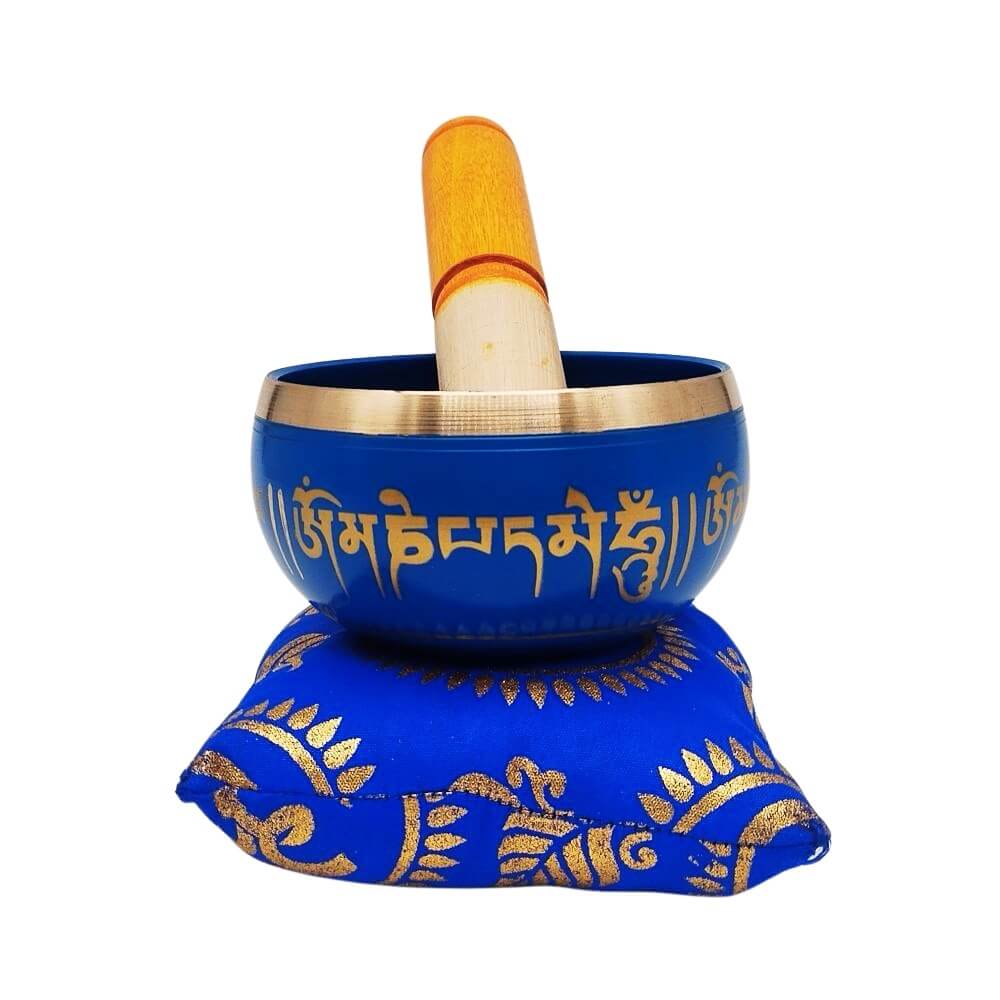 Buddhist singing bowl on blue cushion with striker, front view