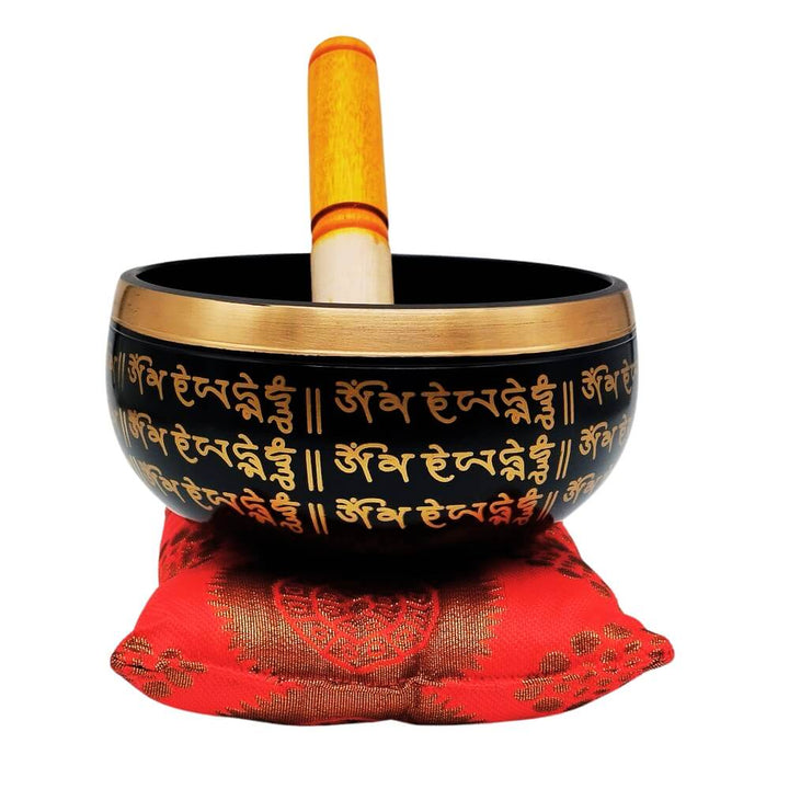 Meditation Singing Bowl on red cushion with striker, front view