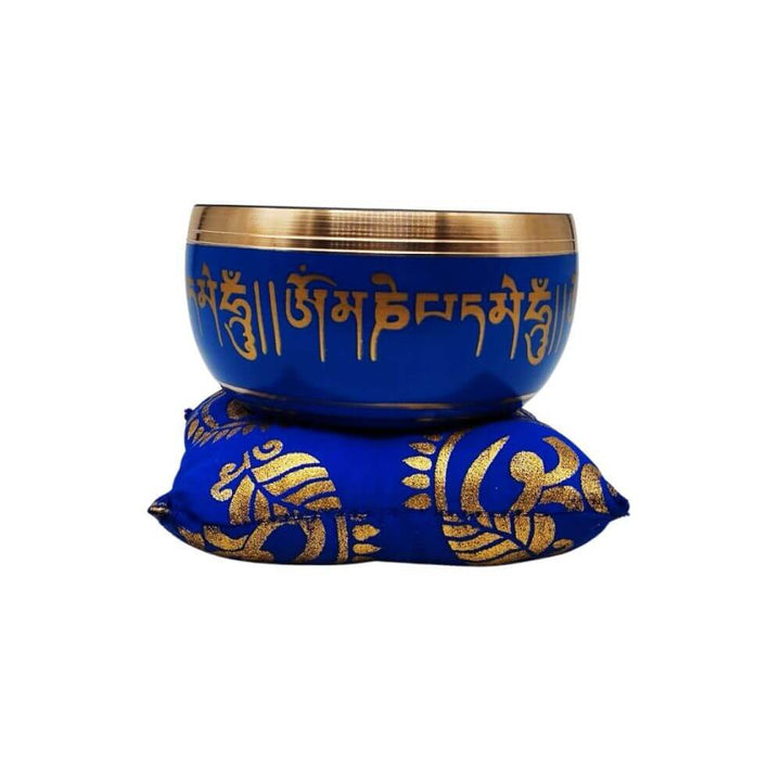 Tibetan singing bowl on blue cushion, front view