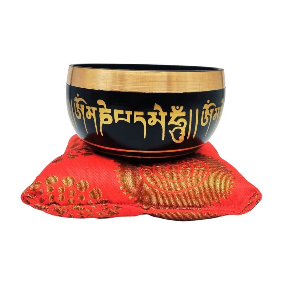 Tibetan singing bowl on red cushion, front view