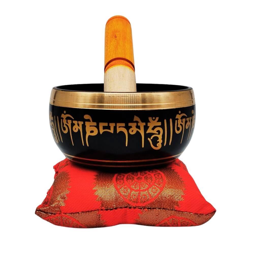Tibetan singing bowl with red cushion and striker, front view